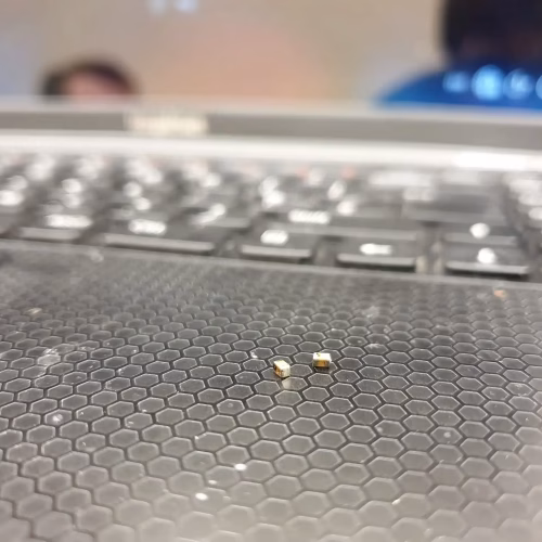 Laptop with broken components Small components on laptop keyboard